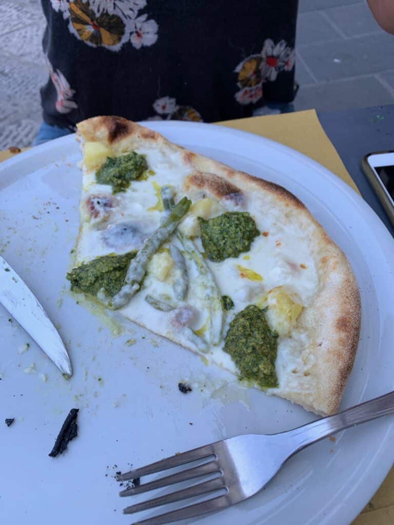 The Pesto Pizza at Molo Modo 21 in Genoa. It's the most unique pizza I've ever eaten. In addition to pesto it has stracchino cheese, green beans, and potatoes on it. 