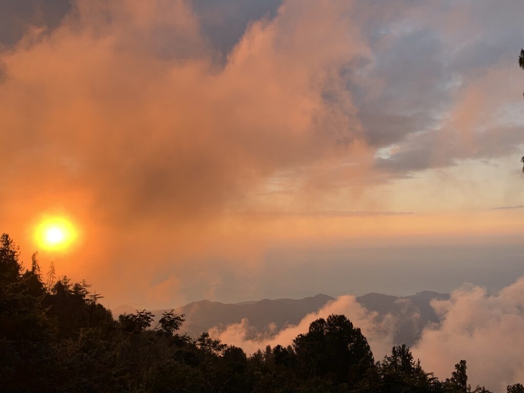 A sunset turns the sky orange in the mountains near Minca, Colombia